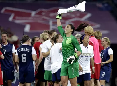 United States' Hope Solo (1) celebrates with teammates after winning the women's