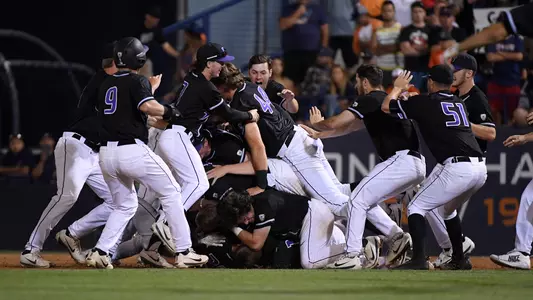Team dog pile after winning Fullerton Super Regional