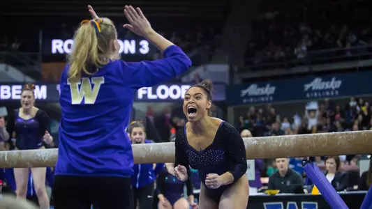 Evanni Roberson celebrates a beam routine