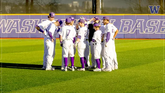 The Huskies gather on the field pre-game.