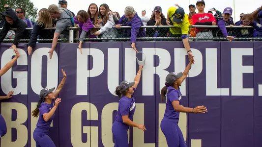 The Huskies high-five fans after advancing to the WCWS