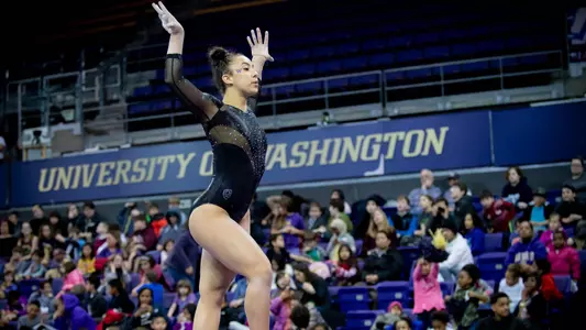 Michaela Nelson performs on beam