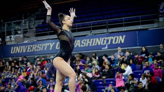 Michaela Nelson performs on beam