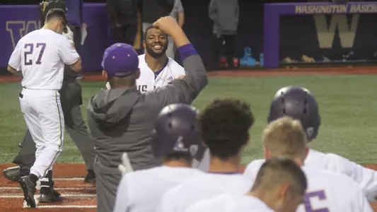 Christian Jones is greeted by his teammates after a home run.