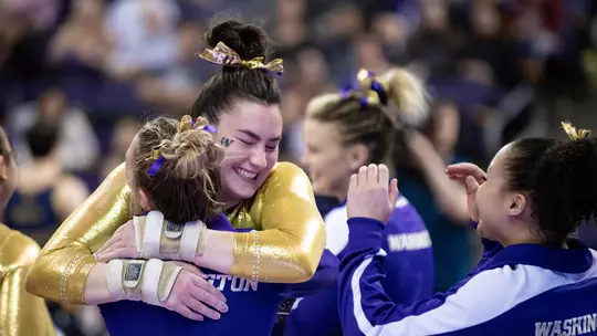 Madison Copiak hugs her teammates after a stuck vault