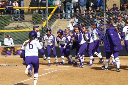 The team celebrates a home run at home plate