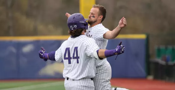 Nick Kahle greets Joe Wainhouse after his homer gave UW a 1-0 lead over USC.
