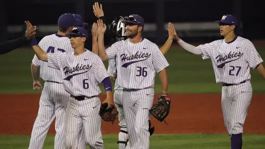The Huskies celebrate the win over Utah.