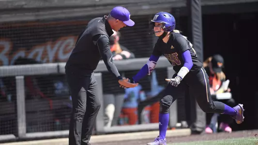 Sis Bates high fives JT D'Amico as she rounds the bases