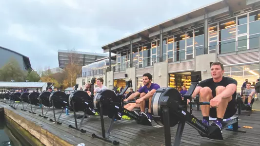 UW men's rowers working out on ergs on the Shellhouse dock.