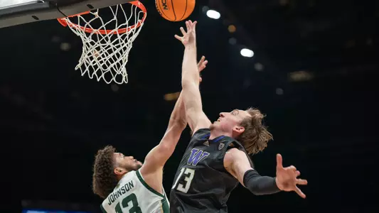 Moses Wood fights for a basket as UW takes on CSU