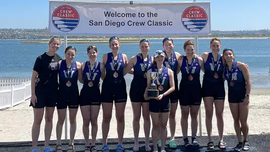 2023 UW women's novice 8 on medal stand at San Diego Crew Classic