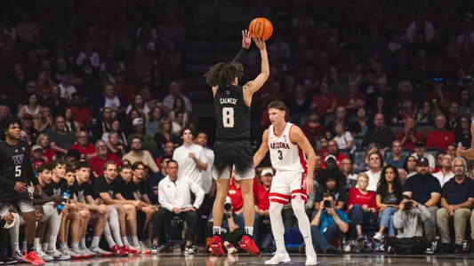 Nate Calmese shoots a three-pointer at No. 4 Arizona