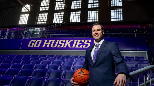 Men's basketball coach Danny Sprinkle in front of the windows in Hec Ed