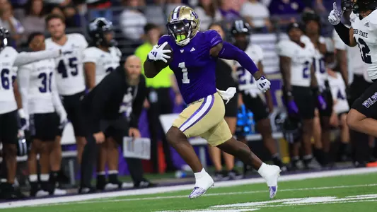 Jonah Coleman runs for a gain against Weber State