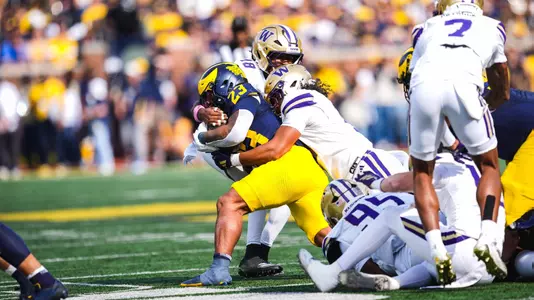 Xe'ree Alexander makes a tackle at Michigan