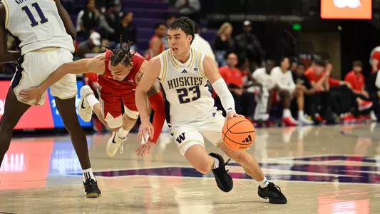 JJ Mandaquit dribbles around a screen against UNLV