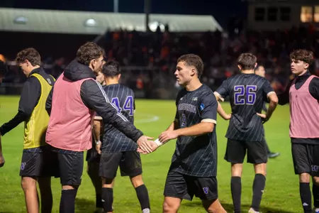Charlie Kosakoff high fives Asher Hestad during Washington's NCAA Tournament match at Oregon State.