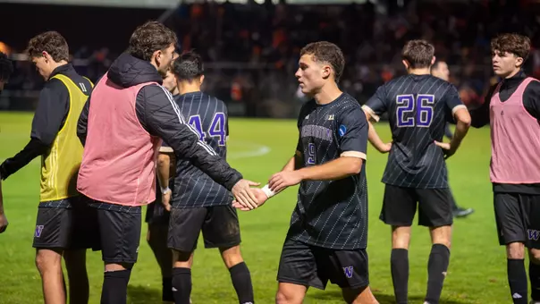 Charlie Kosakoff high fives Asher Hestad during Washington's NCAA Tournament match at Oregon State.