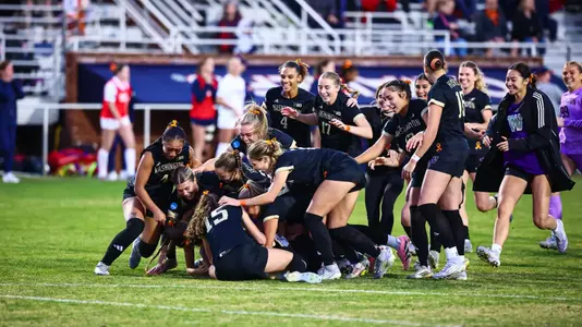 Dawg pile celebration after the penalty shootout victory to reach the NCAA Elite Eight