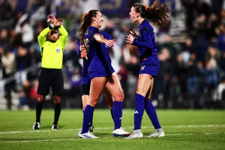 Avery Nguyen and Alex Buck celebrating a goal vs. Minnesota