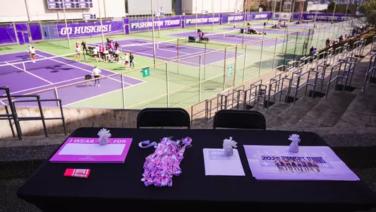 Photo of tennis court from above with team circling on court