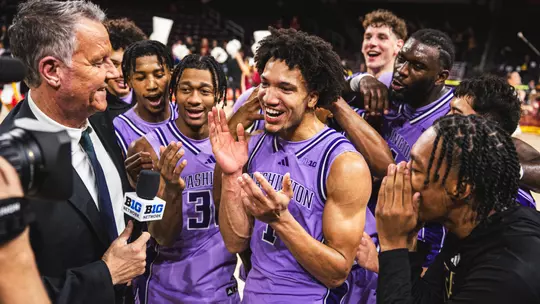Desmond Claude surrounded by teammates during postgame interview at USC