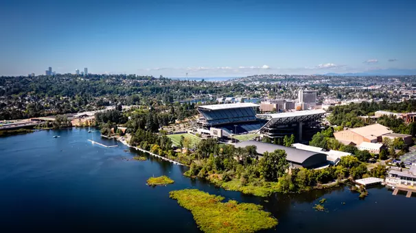 Photo of Alaska Airlines Field at Husky Stadium and UW Athletics village over Lake Washington with Seattle in background