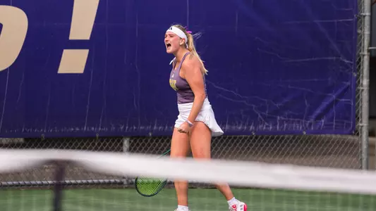 Reece Carter celebrates after winning a point against Stetson at UW