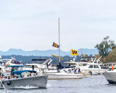 Boats in Husky Harbor flying UW flag
