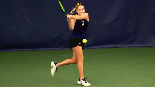 Reece Carter hits tennis ball