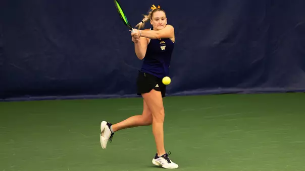 Reece Carter hits tennis ball