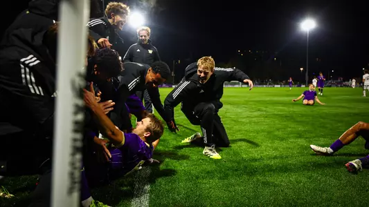 Zach Ramsey slides into the corner after scoring the winning goal vs. Northwestern