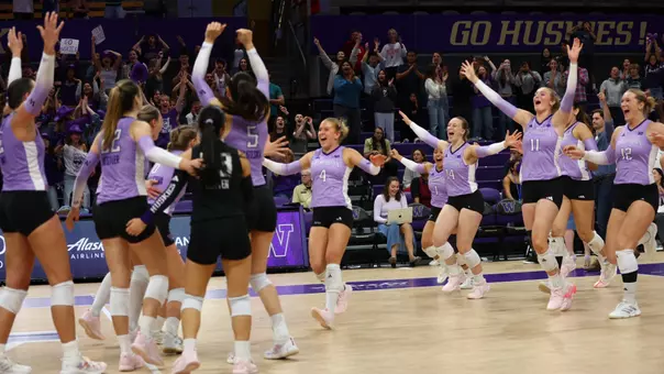 The Huskies run onto the court to celebrate the victory