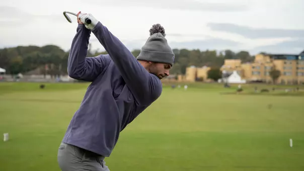 Brock Maulding hits a tee shot on the first hole at the Old Course