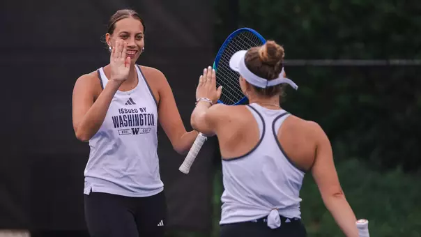 Alexia Jacobs and Marie Weissheim high five during the ITA All-American Championship