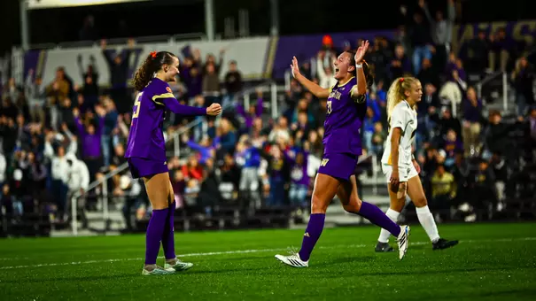 Alex Buck and Avery Nguyen celebrate Washington's winning goal in the 2-1 victory over Iowa