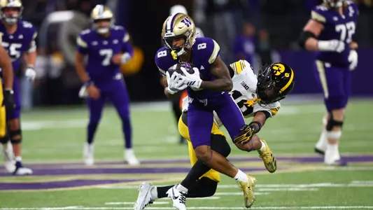 Chris Lawson tackled by Iowa defender