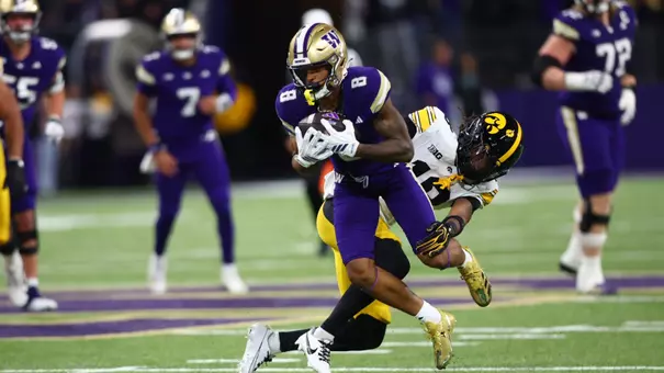Chris Lawson tackled by Iowa defender