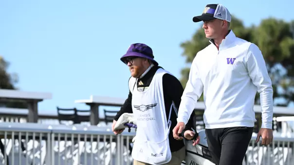 Finn Koelle walking and Alan Murray carrying a bag at the 2025 Genesis Collegiate Showcase