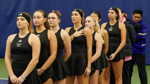 Women's tennis team stands for the national anthem