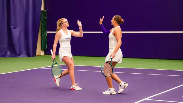 Reece Carter and Jermine Sherif high five during doubles against Utah