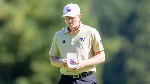 Finn Koelle reads his green book