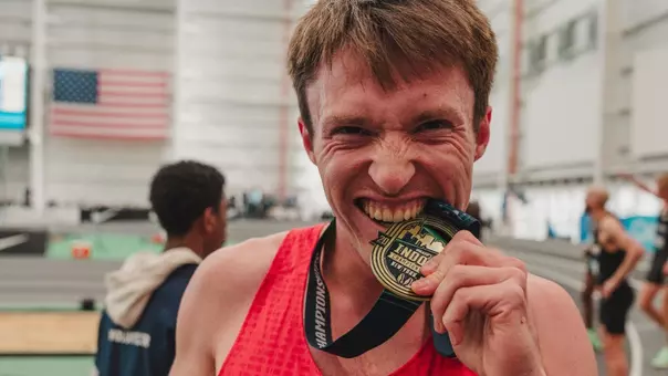 Nathan Green bites his USA Gold medal in the 2026 indoor championships