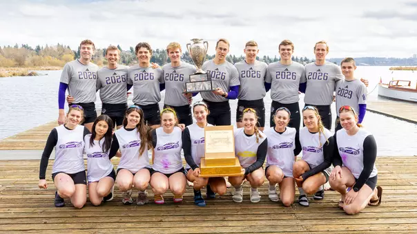 The UW senior men's crew and freshman women's crew pose for a photo with their trophies after having won their races at the 2026 Class Day Regatta.