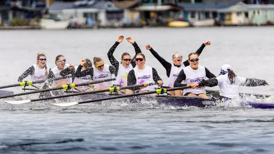 A crew of UW freshman rowers celebrates its win in the 2026 Class Day Regatta, shortly after having finished.