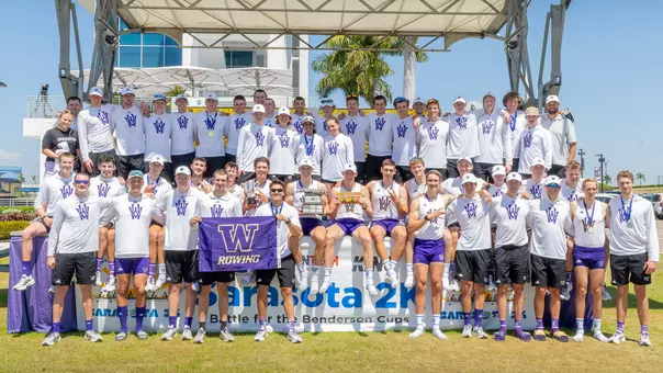 the Washington men's rowing team poses with its trophies on the podium at the 2026 Benderson Cup in Sarasota, Fla.