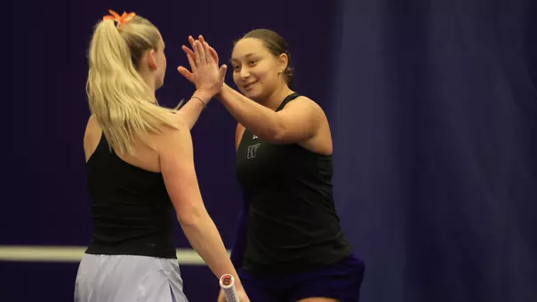 Jermine Sherif and Reece Carter high five during doubles vs. Illinois
