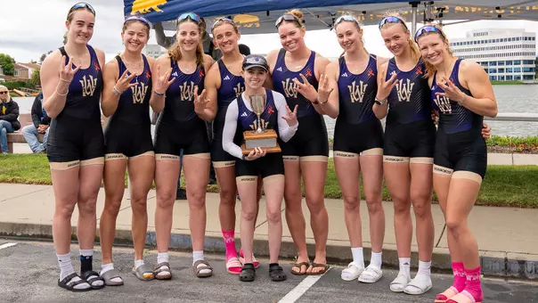 members of Washington's women's rowing team varsity eight crew hold the Simpson Cup after beating California, April 11, 2026