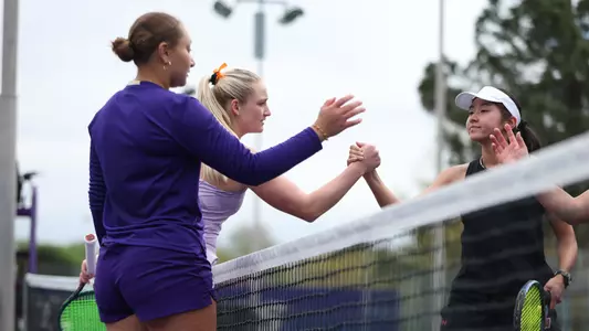 Jermine Sherif and Reece Carter shake hands with their opponents from Wisconsin after doubles